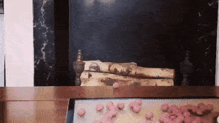 A gif of a rabbit sliding off a table after failing
                to grab a tray full of treats